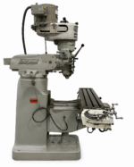 Bridgeport vertical mill seen from the side, with the head tilted over the table
